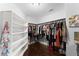 Large walk-in closet with built-in shelving and ample storage for clothes at 1572 Azalea Dr, Lawrenceville, GA 30043