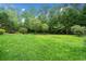 Lush green lawn with mature trees offering a private and serene setting at 2140 Old Orchard Lane Ln, Canton, GA 30114