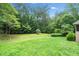 Spacious backyard with green grass and mature trees, ideal for outdoor activities at 2140 Old Orchard Lane Ln, Canton, GA 30114