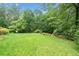 Spacious backyard offering a serene, tree-lined landscape, perfect for outdoor activities and relaxation at 2140 Old Orchard Lane Ln, Canton, GA 30114