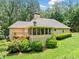 Back of house showing screened porch, deck, and lush lawn at 2140 Old Orchard Lane Ln, Canton, GA 30114