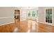 Open-concept dining area with hardwood floors, a bay window, and an adjacent kitchen at 2140 Old Orchard Lane Ln, Canton, GA 30114