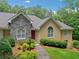 Charming home with stone accents, arched windows, and a well-maintained landscaped front yard at 2140 Old Orchard Lane Ln, Canton, GA 30114