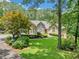 Charming home featuring a stone accent, manicured front yard and vibrant landscaping with mature trees at 2140 Old Orchard Lane Ln, Canton, GA 30114