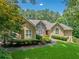 A beautiful home with manicured landscaping, and an inviting walkway to the front door at 2140 Old Orchard Lane Ln, Canton, GA 30114