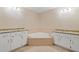 Spacious bathroom with dual vanities, granite countertops, and a corner jetted tub at 2140 Old Orchard Lane Ln, Canton, GA 30114