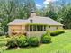 Back exterior featuring a deck, screened in porch and lush green lawn at 2140 Old Orchard Ln, Canton, GA 30114