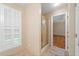 Bright bathroom with tiled floors, a glass shower door, and a window with white shutters at 2140 Old Orchard Ln, Canton, GA 30114