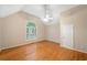 Bedroom featuring hardwood floors, vaulted ceilings, and a window with shutters at 2140 Old Orchard Ln, Canton, GA 30114