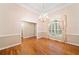 Formal dining room featuring hardwood floors, classic chandelier, and a large window with elegant drapery at 2140 Old Orchard Ln, Canton, GA 30114