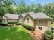 Charming home exterior featuring manicured landscaping and a stone accent wall at 2140 Old Orchard Ln, Canton, GA 30114