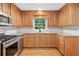 Classic kitchen featuring wooden cabinets, granite countertops, and stainless steel appliances at 2140 Old Orchard Ln, Canton, GA 30114