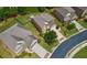 Aerial view showcases the home's manicured lawn and landscaped front yard with a long driveway at 3015 Arbor Song Ct, Cumming, GA 30041