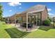 Backyard patio with outdoor dining area and a well-manicured lawn at 3015 Arbor Song Ct, Cumming, GA 30041