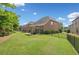 Spacious, fenced backyard with lush green lawn and a covered patio, perfect for outdoor entertaining at 3015 Arbor Song Ct, Cumming, GA 30041
