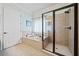 Bathroom featuring a soaking tub, shower with glass door, and neutral tile at 3015 Arbor Song Ct, Cumming, GA 30041