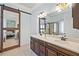 Bathroom featuring a double sink vanity with a large mirror and a barn door leading to bedroom at 3015 Arbor Song Ct, Cumming, GA 30041
