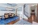 Dining room with elegant chandelier, wainscoting, and adjacent staircase at 3015 Arbor Song Ct, Cumming, GA 30041