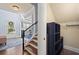 Bright foyer with hardwood floors, staircase, large mirror, and storage cubbies at 3015 Arbor Song Ct, Cumming, GA 30041