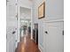 Hallway with wood floors, a mini fridge, and views into the kitchen and dining area at 3015 Arbor Song Ct, Cumming, GA 30041