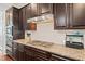 Gourmet kitchen features granite countertops, stainless steel appliances, and custom cabinetry at 3015 Arbor Song Ct, Cumming, GA 30041