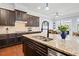 Close-up on a kitchen island with granite counters, stainless steel appliances, and modern fixtures at 3015 Arbor Song Ct, Cumming, GA 30041