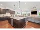 Open-concept kitchen with granite counters and a cozy living space with stone fireplace at 3015 Arbor Song Ct, Cumming, GA 30041