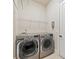 Convenient laundry room with modern washer and dryer and overhead storage at 3015 Arbor Song Ct, Cumming, GA 30041