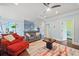Bright living room with hardwood floors, a ceiling fan, a colorful rug, and neutral walls at 3015 Arbor Song Ct, Cumming, GA 30041