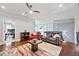 Living area featuring a ceiling fan, hardwood floors, a colorful rug, and neutral walls at 3015 Arbor Song Ct, Cumming, GA 30041