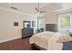 Comfortable bedroom featuring a ceiling fan, hardwood floors, and a dresser at 3015 Arbor Song Ct, Cumming, GA 30041