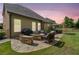 Back patio with stone fire pit, wicker furniture, grill and outdoor dining area at 3015 Arbor Song Ct, Cumming, GA 30041