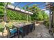 Spacious outdoor dining area on a stone patio covered with an awning at 3015 Arbor Song Ct, Cumming, GA 30041