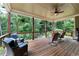 Inviting covered porch with comfortable seating, ceiling fan, and wooded views, perfect for relaxation and outdoor living at 32 Pullman Trl, Acworth, GA 30101