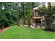 Spacious, green backyard featuring a patio area perfect for entertaining and enjoying the peaceful, wooded surroundings at 32 Pullman Trl, Acworth, GA 30101