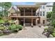Spacious backyard featuring an upper deck with an outdoor lounge area, waterfall, and brick patio at 32 Pullman Trl, Acworth, GA 30101