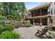 Multi-level backyard with paver patio, lush landscaping, and a covered deck, offering ample space for outdoor enjoyment at 32 Pullman Trl, Acworth, GA 30101