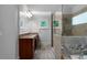 Bathroom with double sink vanity, framed mirror, a glass enclosed shower and large window at 32 Pullman Trl, Acworth, GA 30101