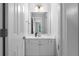 Bathroom vanity with white cabinet, framed mirror and chrome hardware at 32 Pullman Trl, Acworth, GA 30101