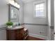 Stylish half-bath featuring a wood vanity, granite countertop, and decorative mirror at 32 Pullman Trl, Acworth, GA 30101