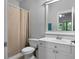 Bright bathroom with a white vanity, shower with curtain, and natural light at 32 Pullman Trl, Acworth, GA 30101