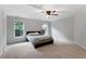 A serene bedroom featuring plush carpeting, a ceiling fan, and two windows for natural light at 32 Pullman Trl, Acworth, GA 30101