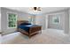 Bedroom with bright paint, neutral carpet, three windows and a ceiling fan at 32 Pullman Trl, Acworth, GA 30101
