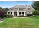 Charming home with a large, manicured lawn, covered front porch, and inviting curb appeal at 32 Pullman Trl, Acworth, GA 30101