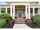 Inviting front entrance with brick steps, decorative planters, and a covered porch with columns at 32 Pullman Trl, Acworth, GA 30101
