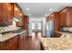 Spacious kitchen with wood cabinets, granite countertops, and stainless steel appliances at 32 Pullman Trl, Acworth, GA 30101