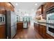 Modern kitchen with stainless steel appliances, granite countertops, and dark wood cabinets at 32 Pullman Trl, Acworth, GA 30101