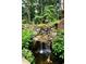 Close-up of a serene koi pond with a gentle waterfall and lush surrounding greenery, creating a peaceful backyard retreat at 32 Pullman Trl, Acworth, GA 30101