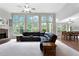 Spacious living room with fireplace, a ceiling fan, and views of the dining area at 32 Pullman Trl, Acworth, GA 30101