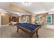 Game room boasts a pool table, dining area, and adjacent living space with natural light at 32 Pullman Trl, Acworth, GA 30101